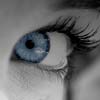 Black and white image of an eye with the blue iris enhanced, used on the product packaging.